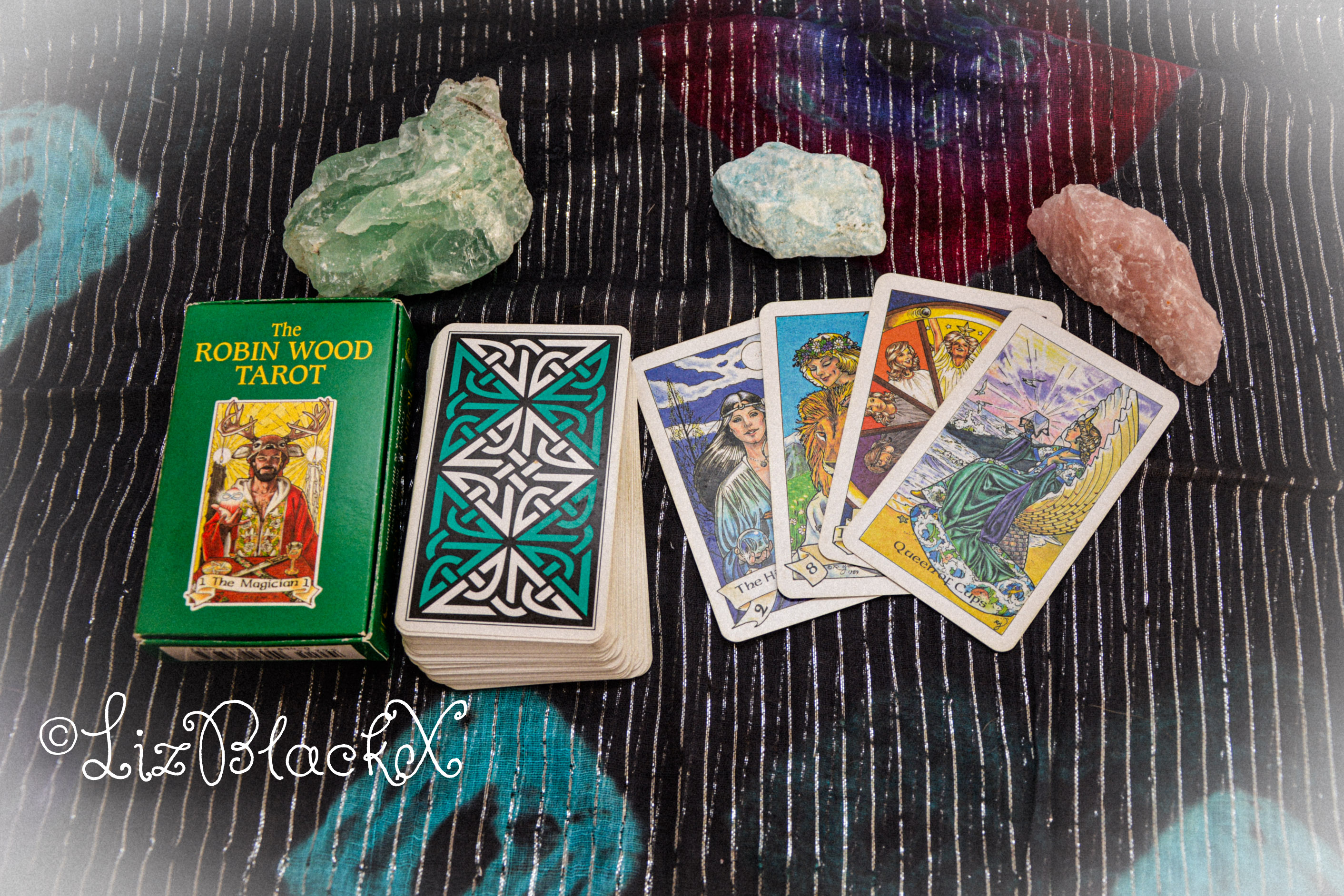Photo of gemstones and the Robin Wood Tarot deck, as illustration to the text My Spirituality: From Meditation to Tarot by Liz BlackX