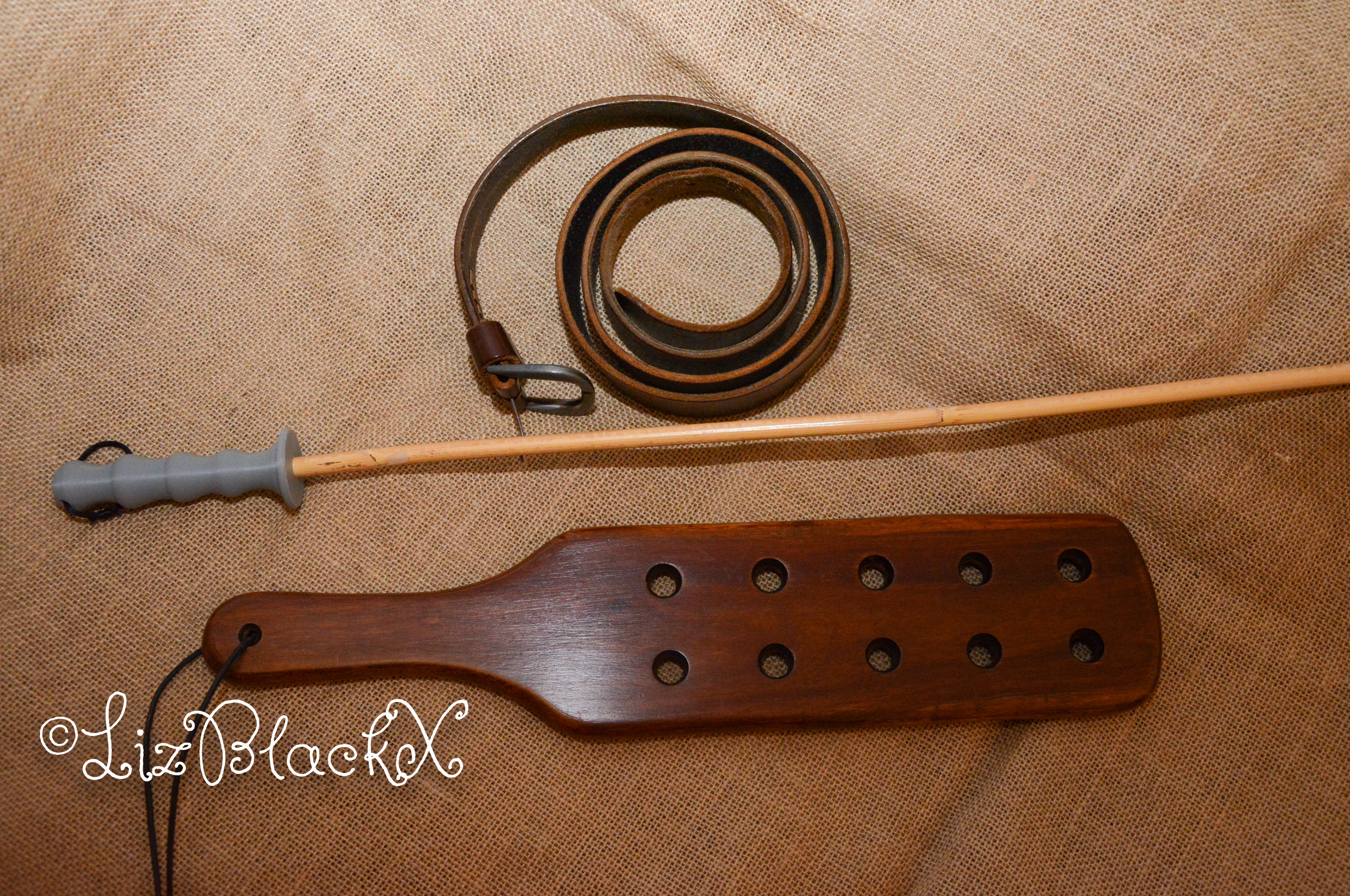 Picture of a cane, a belt and a paddle as illustration to a blog post about spanking
Copyright Liz BlackX