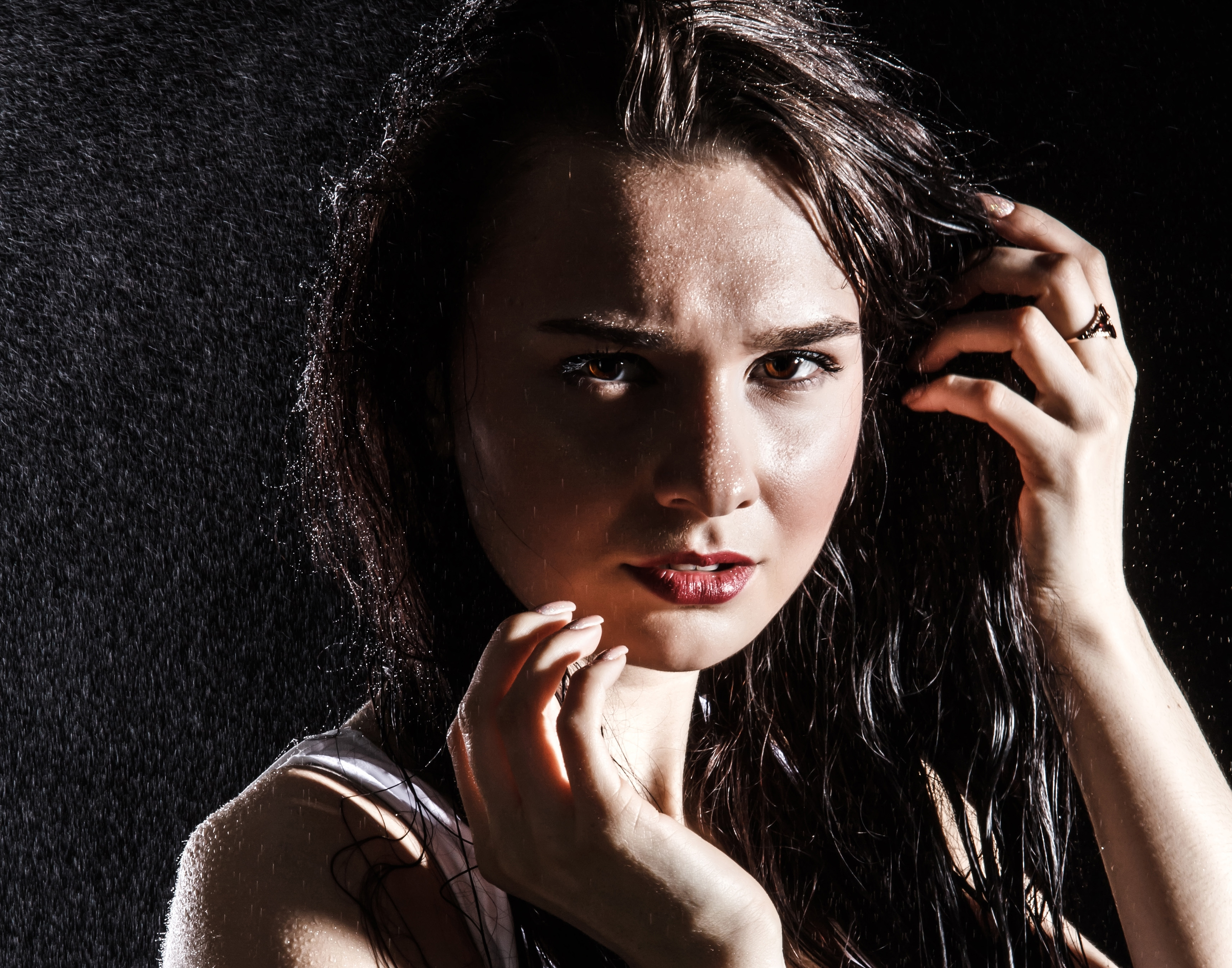 Dark haired woman looking into the camera anxiously

Picture from Depositphotos.com